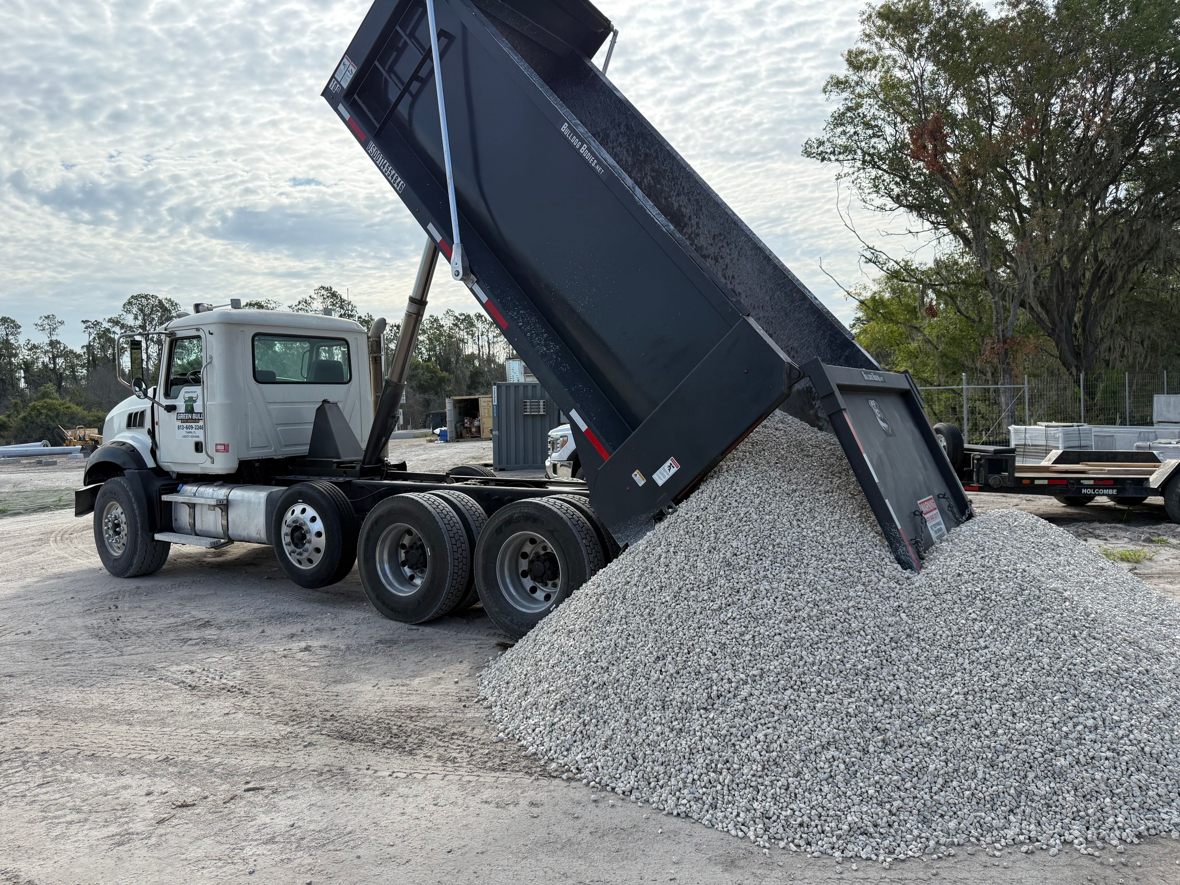 Dump truck delivering limestone aggregate