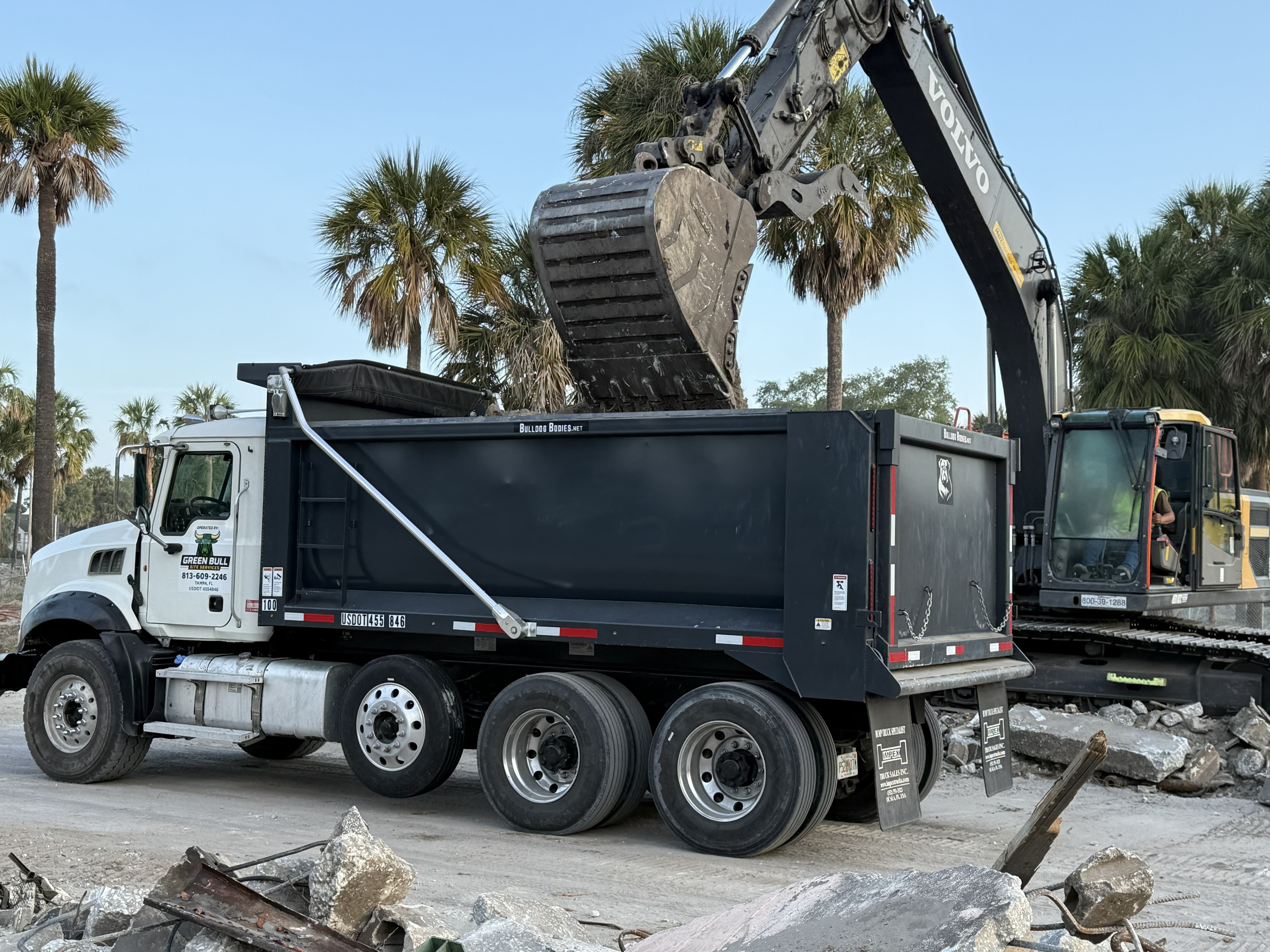 Dump truck being loaded at demolition site